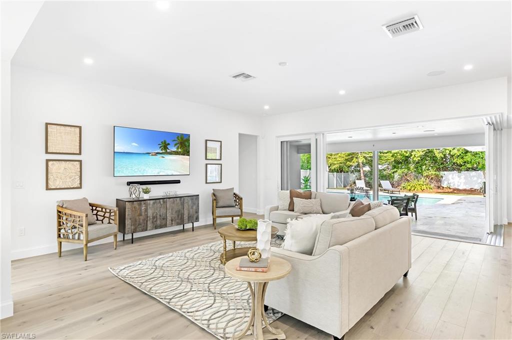 2001 Alamanda Drive Naples, FL 34102 - Photo 9 of 32 a living room with furniture and a flat screen tv