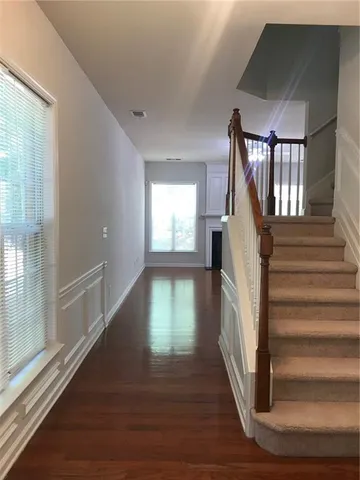 a view of entryway and hall with wooden floor