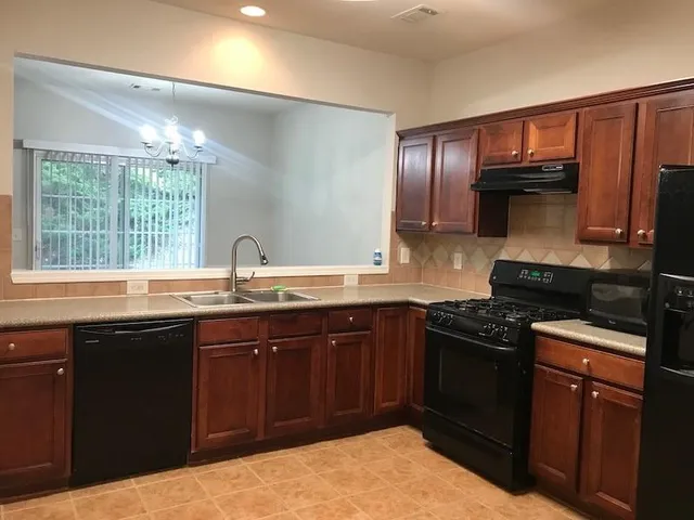 a kitchen with a sink stove and cabinets