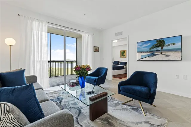 a living room with furniture and a chandelier