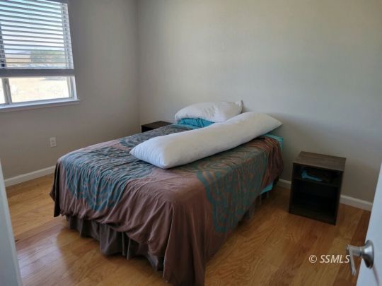 133 South Locust Street Ridgecrest, CA 93555 - Photo 20 of 26 a bed sitting in a bedroom next to a window
