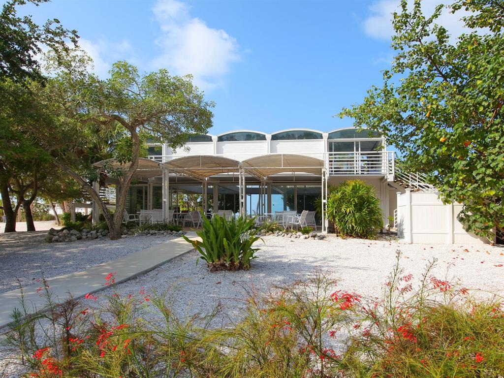 7219 Pine Needle Road Sarasota, FL 34242 - Photo 17 of 30 a front view of a house with a yard