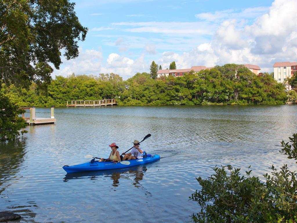 7219 Pine Needle Road Sarasota, FL 34242 - Photo 21 of 30 a front view of a lake with table and chairs