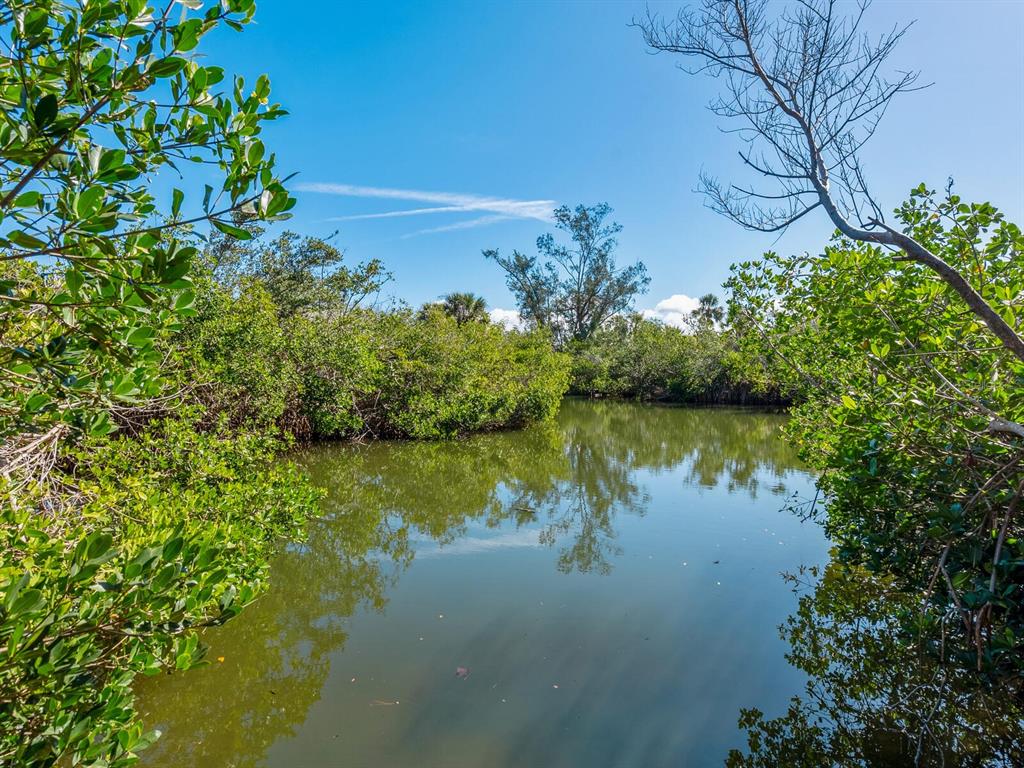 7219 Pine Needle Road Sarasota, FL 34242 - Photo 3 of 30 a view of lake with green space
