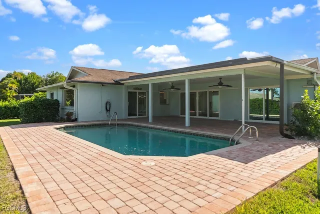 a view of a house with backyard porch and sitting area