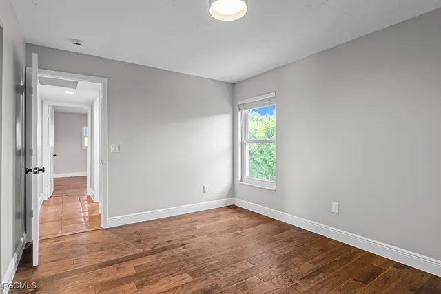 a view of walk in closet with empty racks
