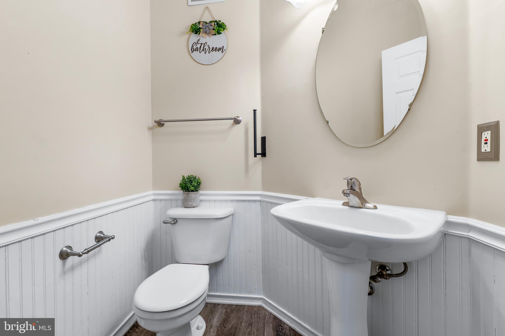 1067 Campbell Meadows Road Owings Mills, MD 21117 - Photo 11 of 32 a bathroom with a sink a toilet and a mirror