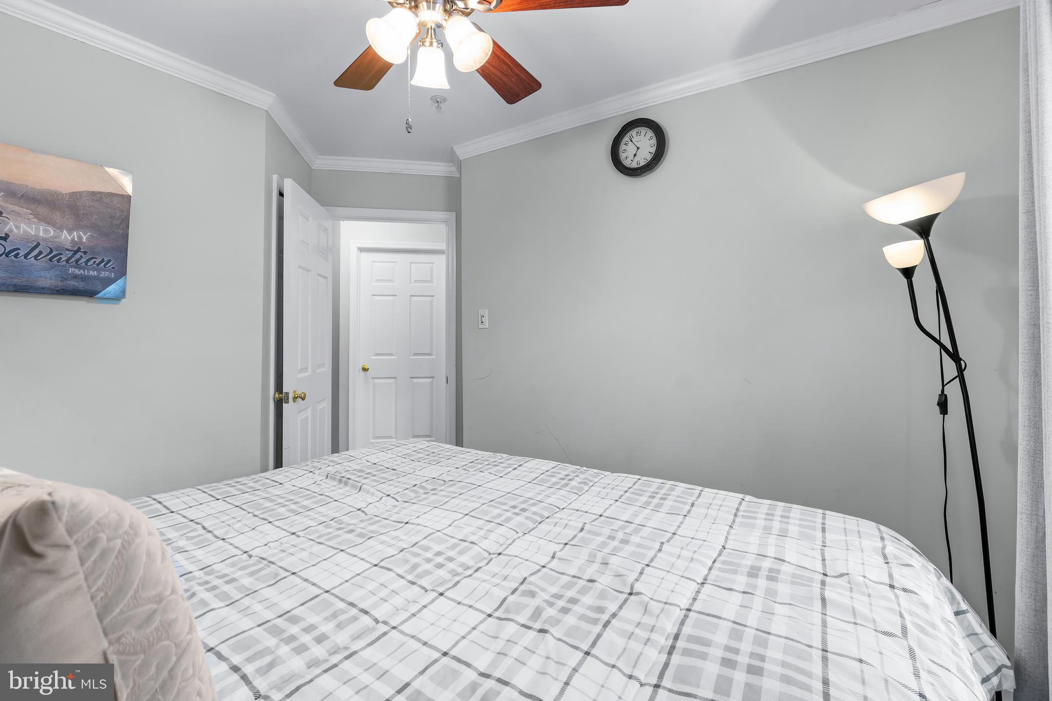 1067 Campbell Meadows Road Owings Mills, MD 21117 - Photo 18 of 32 a bedroom with a bed and a chandelier