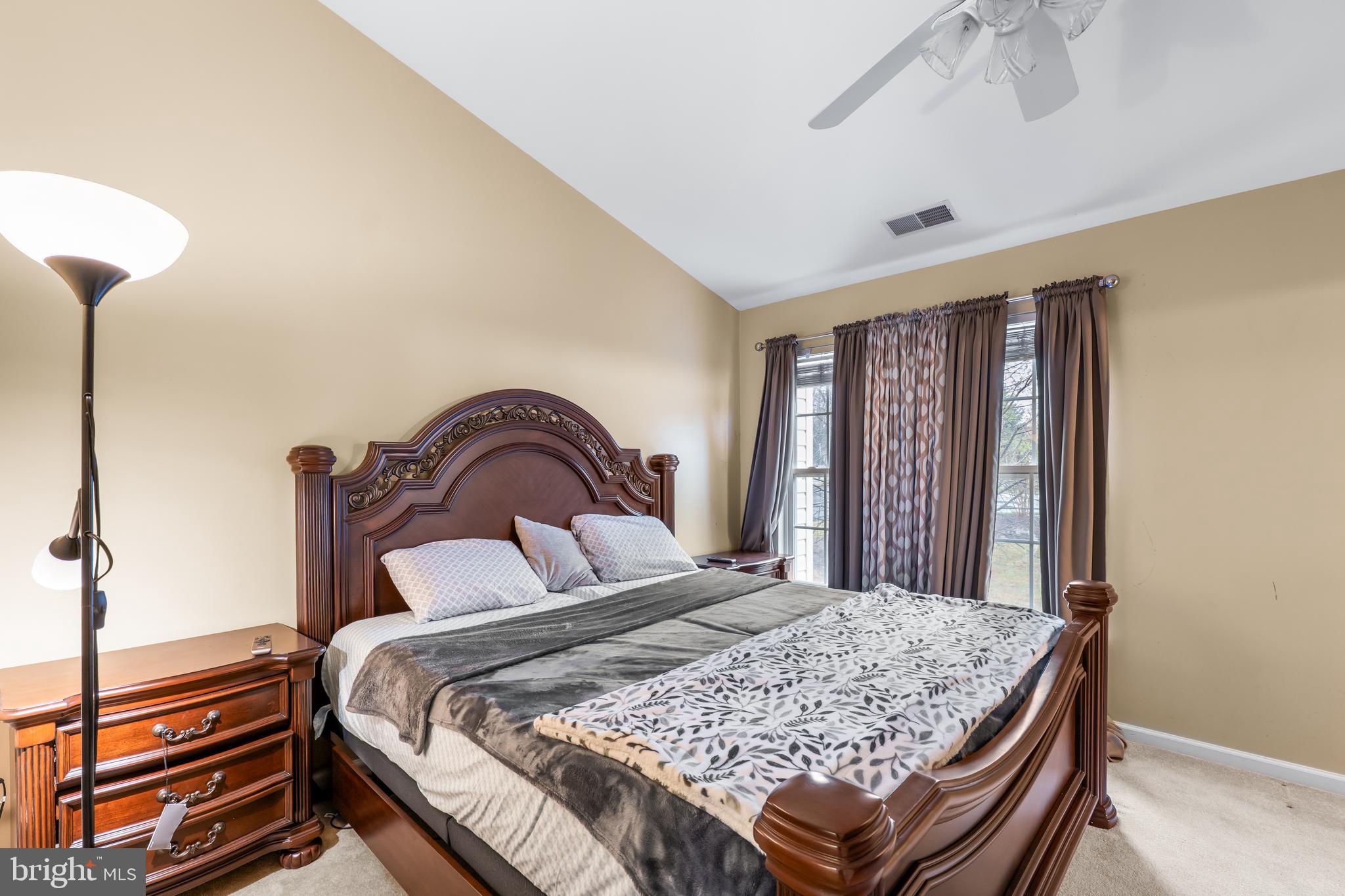 1067 Campbell Meadows Road Owings Mills, MD 21117 - Photo 19 of 32 a bedroom with a bed and a dresser with mirror
