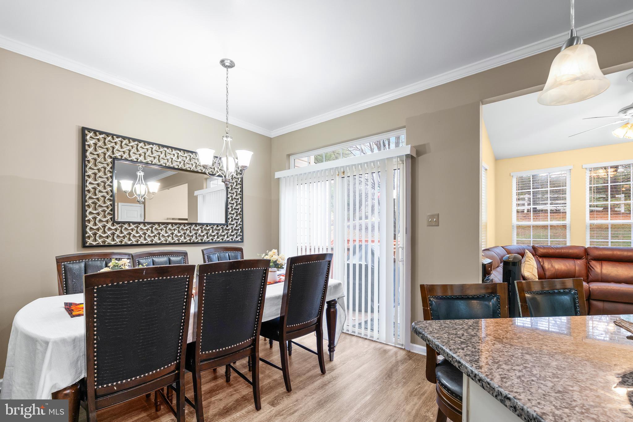 1067 Campbell Meadows Road Owings Mills, MD 21117 - Photo 2 of 32 a dining room with furniture a chandelier and wooden floor
