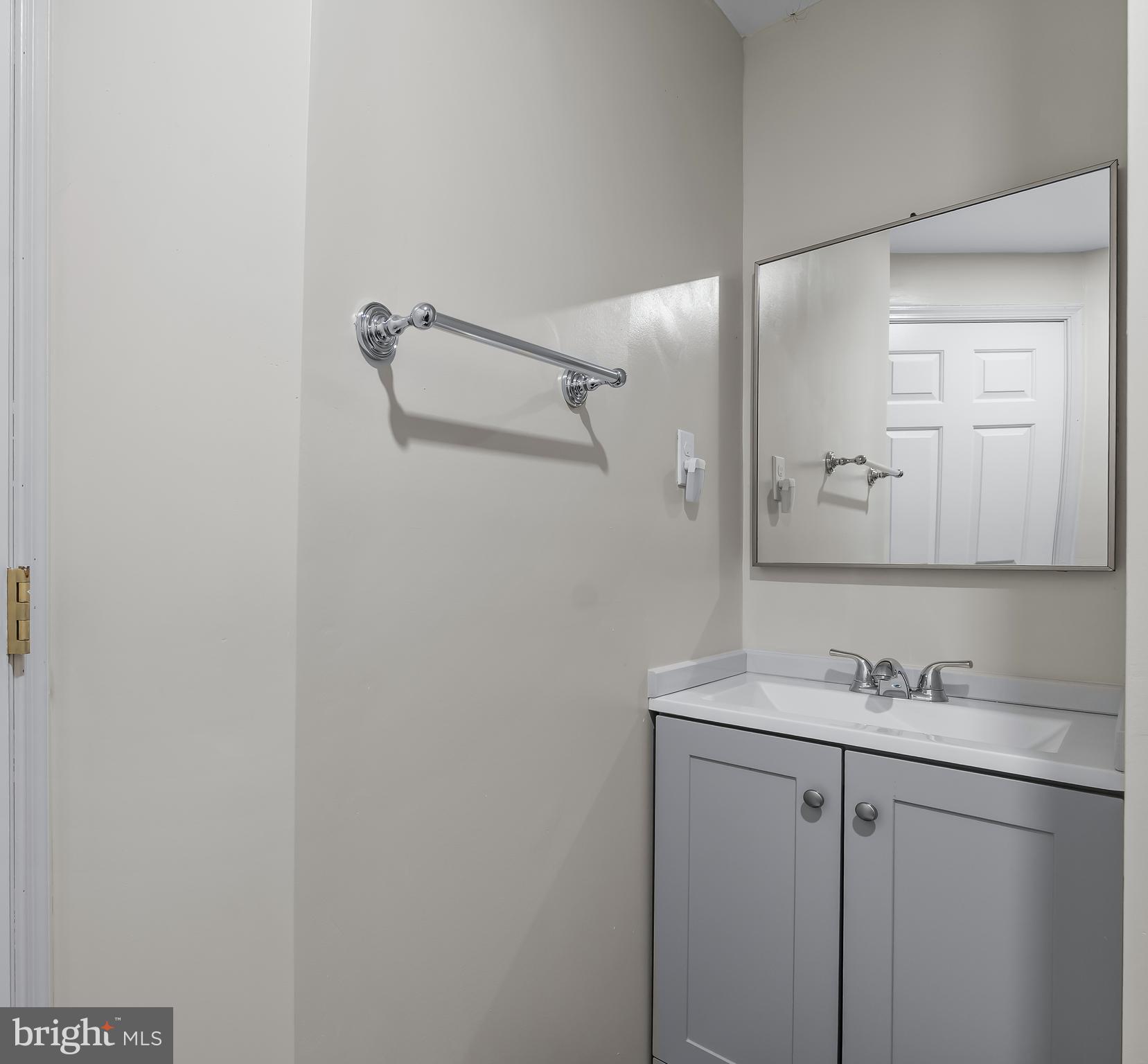 1067 Campbell Meadows Road Owings Mills, MD 21117 - Photo 27 of 32 a bathroom with a granite countertop sink mirror and vanity