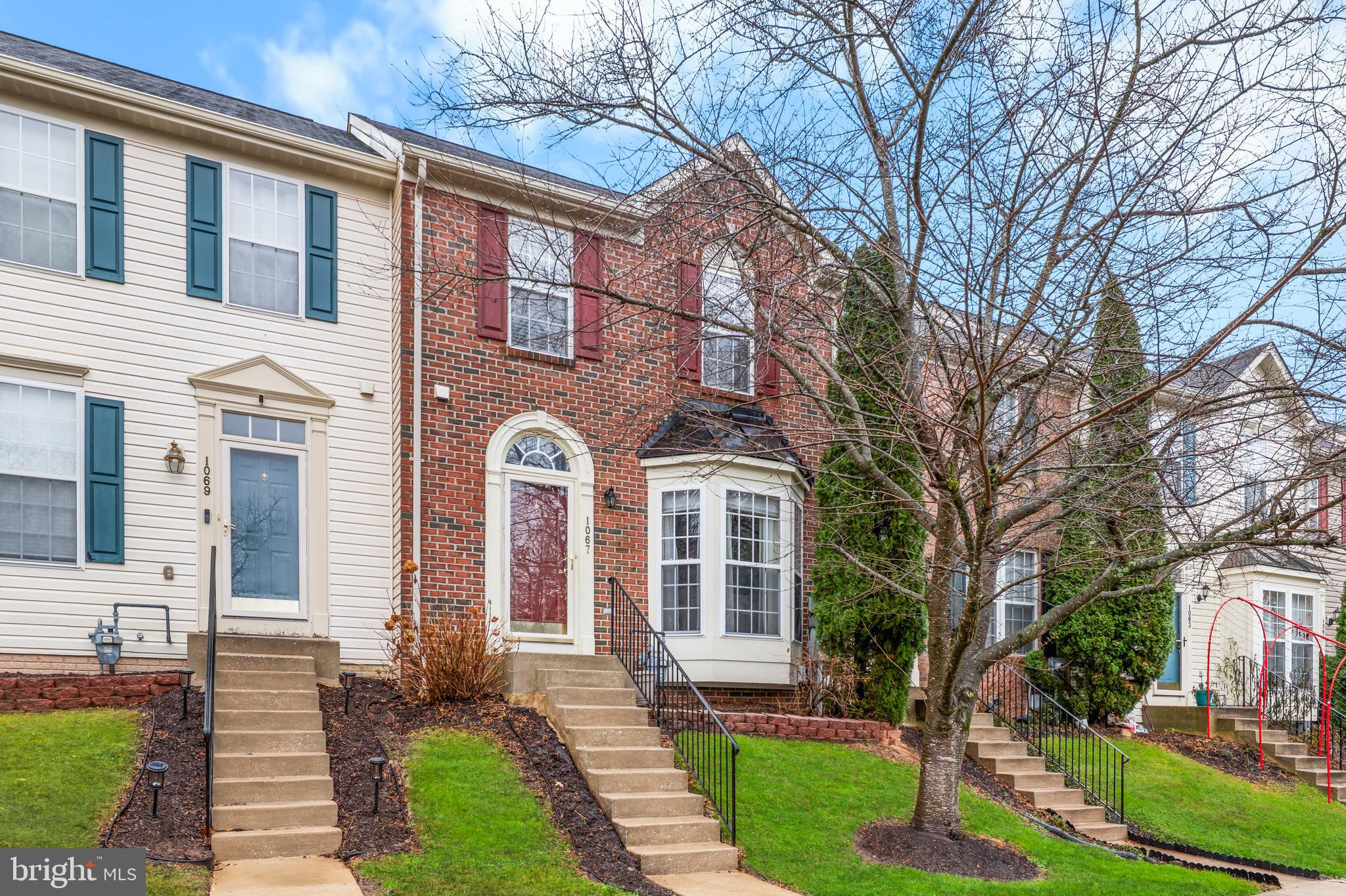 1067 Campbell Meadows Road Owings Mills, MD 21117 - Photo 3 of 32 a front view of a house with yard and green space