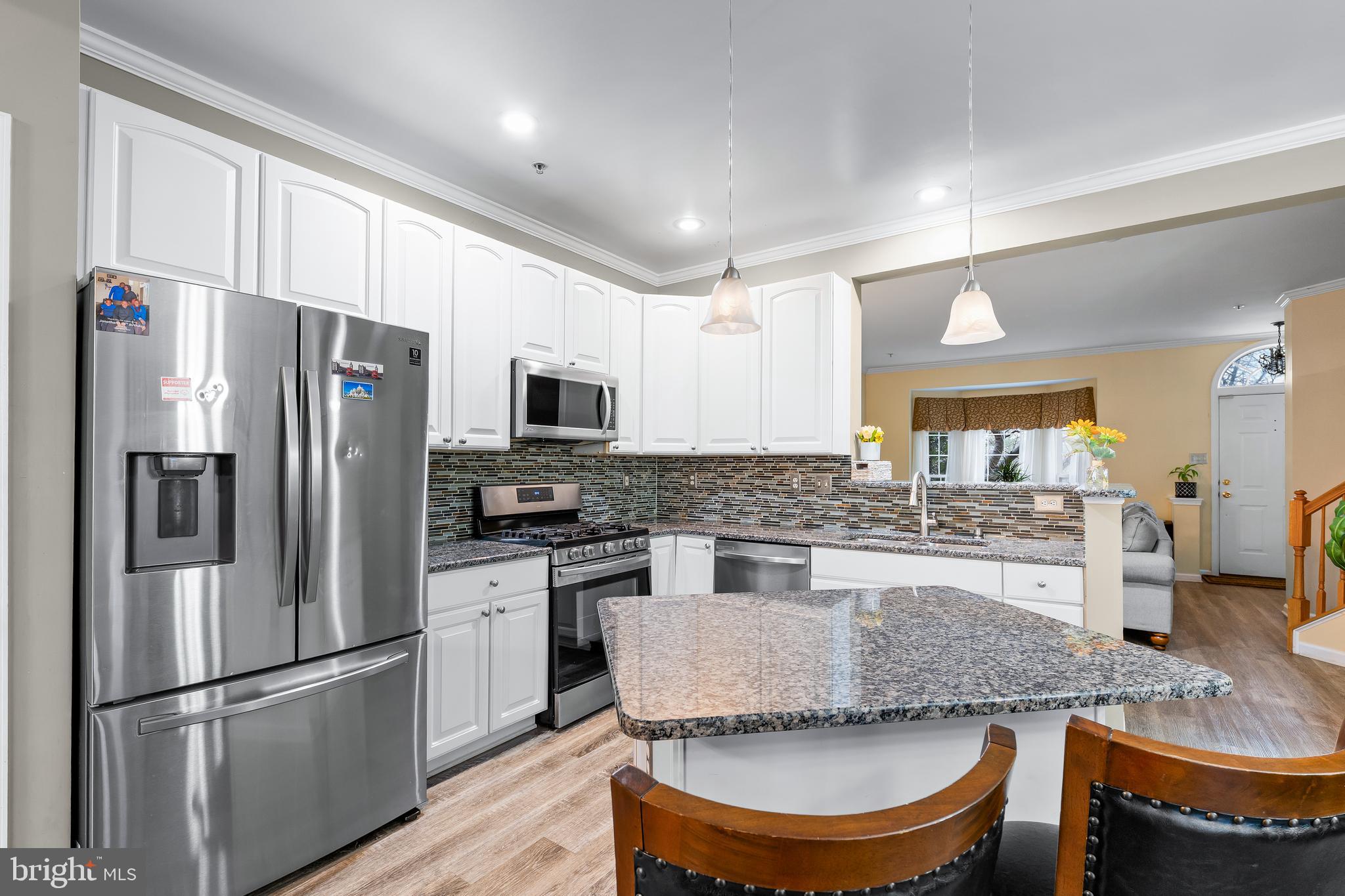 1067 Campbell Meadows Road Owings Mills, MD 21117 - Photo 9 of 32 a kitchen with stainless steel appliances granite countertop a stove refrigerator sink and cabinets