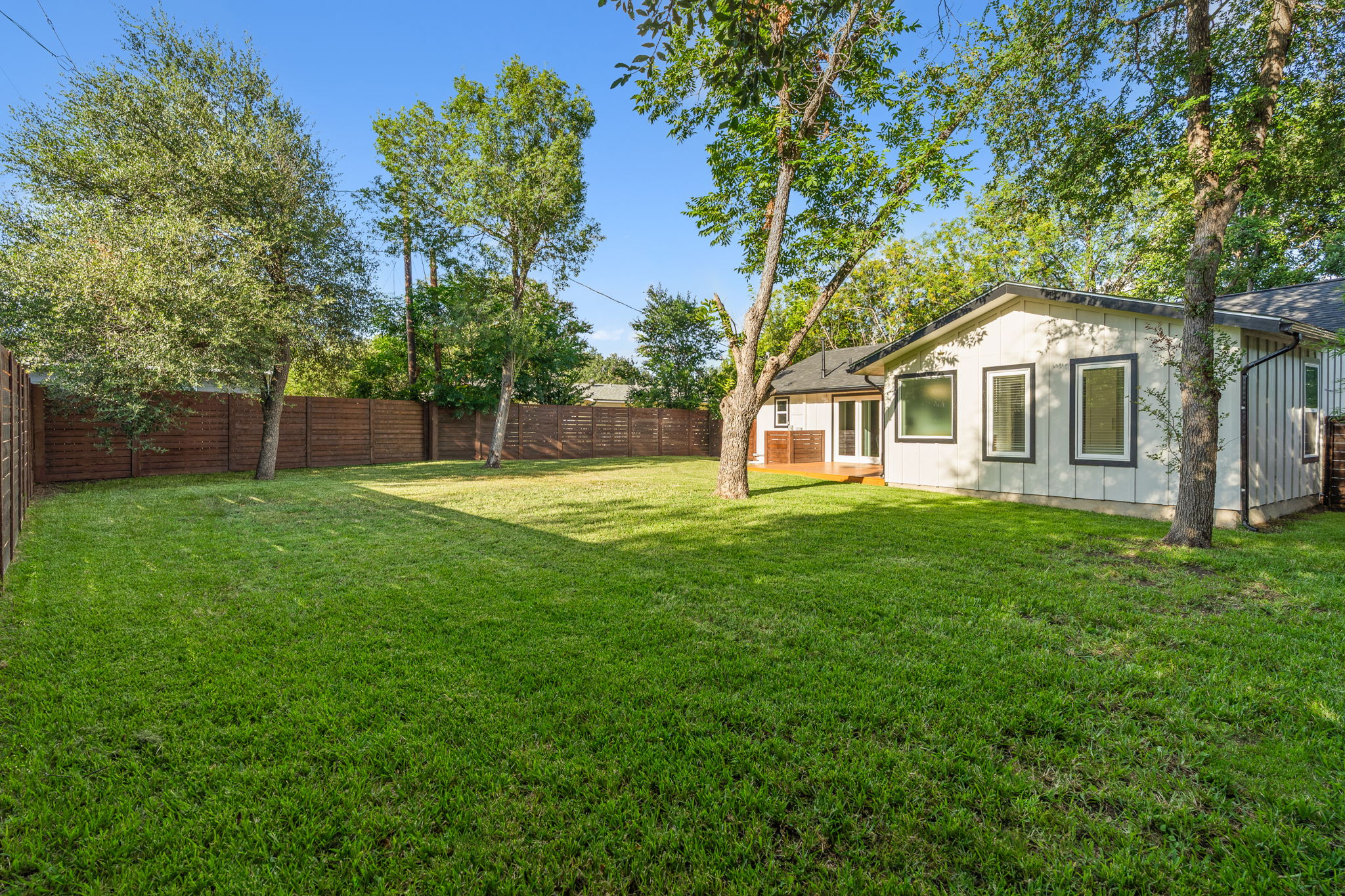 4802 Brighton Road Austin, TX 78745 - Photo 4 of 30 Expansive fenced backyard offers plenty of room for outdoor living, recreation, or the addition of a future detached garage, workshop, guest house, or other accessory structure.