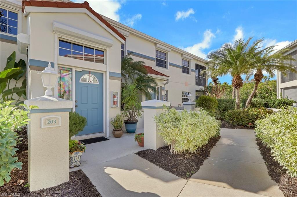 10801 Crooked River Road, Unit 203 Estero, FL 34135 - Photo 3 of 27 a front view of a house with a yard