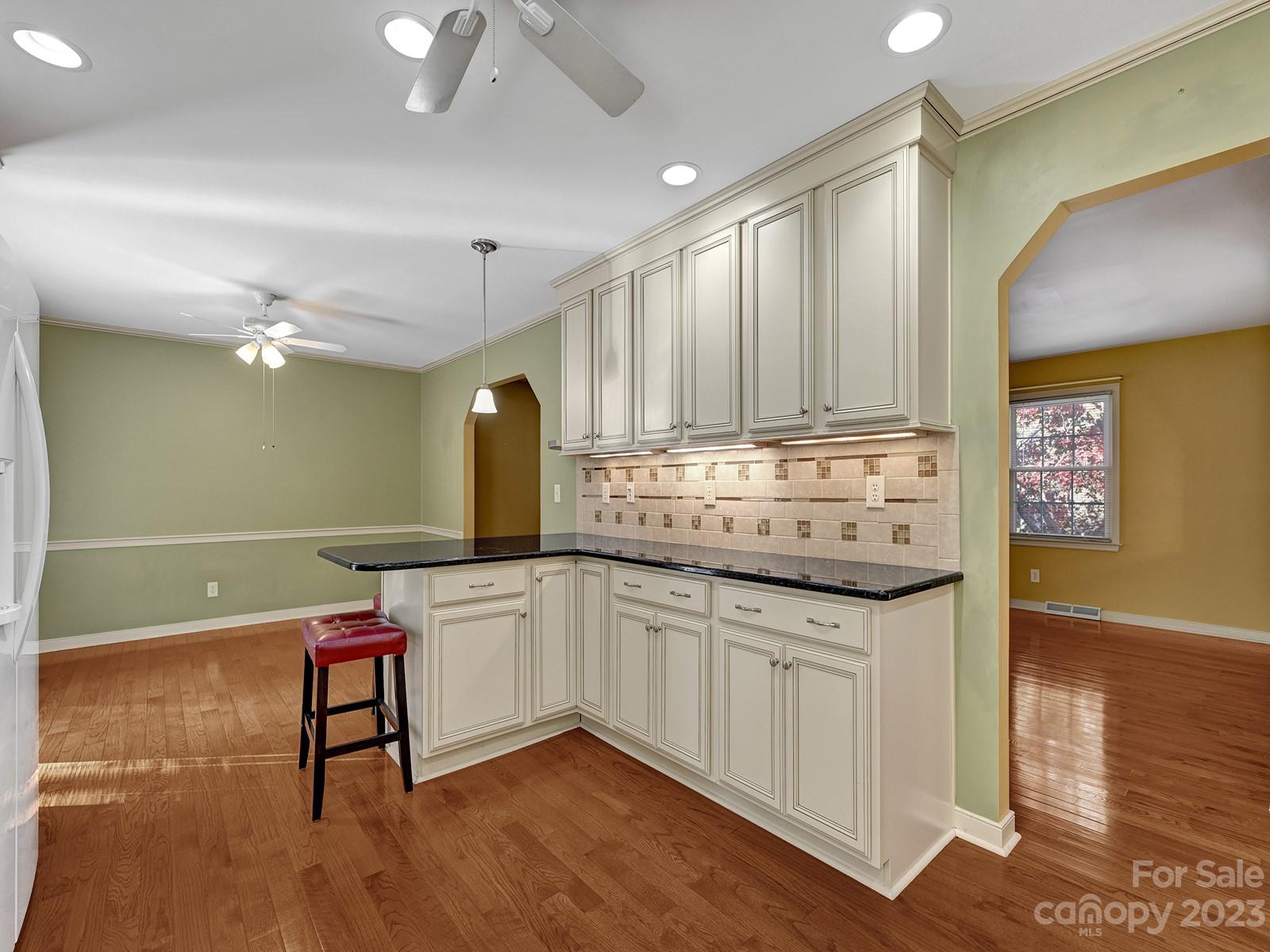 4130 Witherow Road Winston-Salem, NC 27106 - Photo 12 of 39 a kitchen with granite countertop a sink cabinets and wooden floor