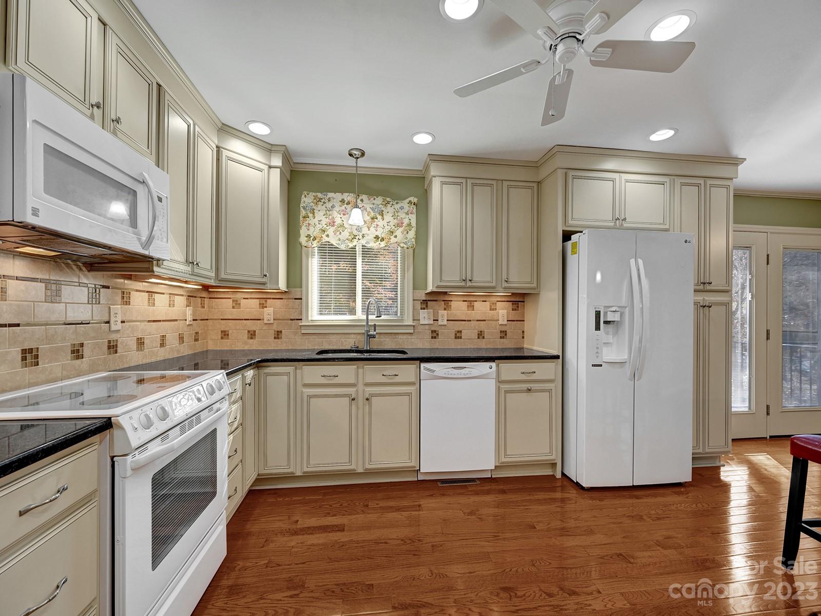 4130 Witherow Road Winston-Salem, NC 27106 - Photo 14 of 39 a kitchen with granite countertop a refrigerator and a sink