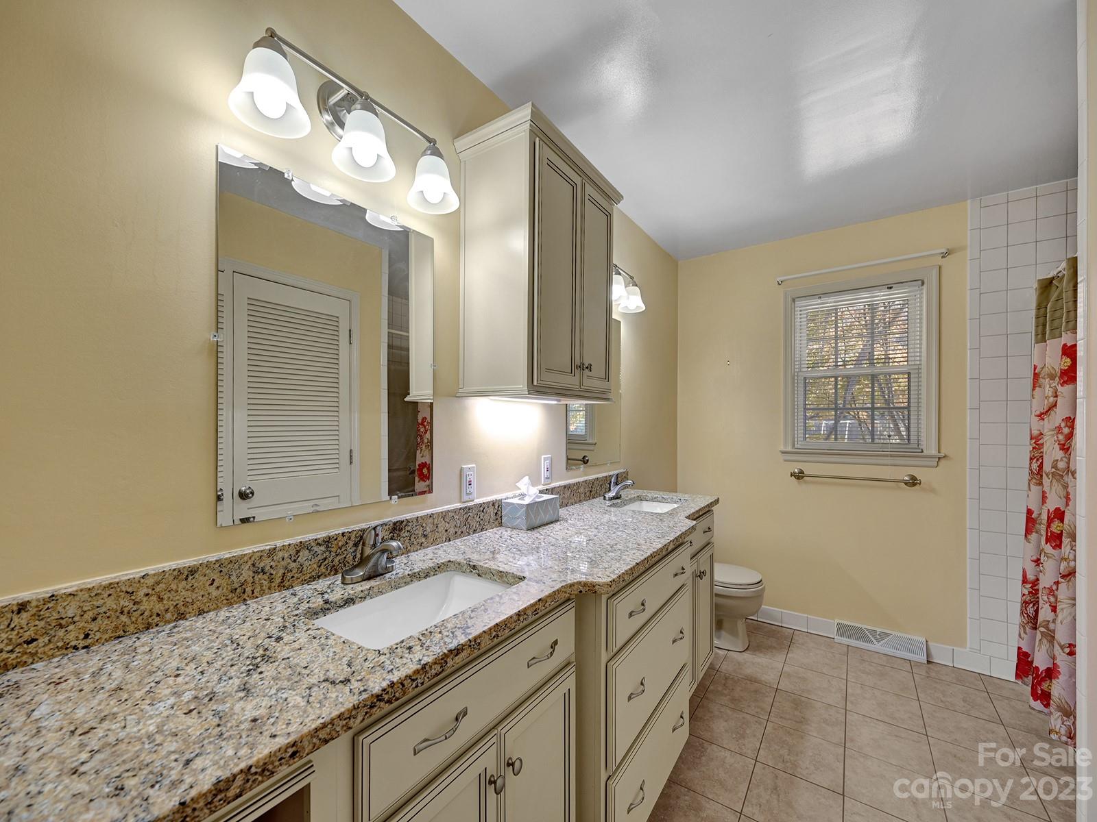 4130 Witherow Road Winston-Salem, NC 27106 - Photo 17 of 39 a bathroom with a granite countertop sink and a mirror
