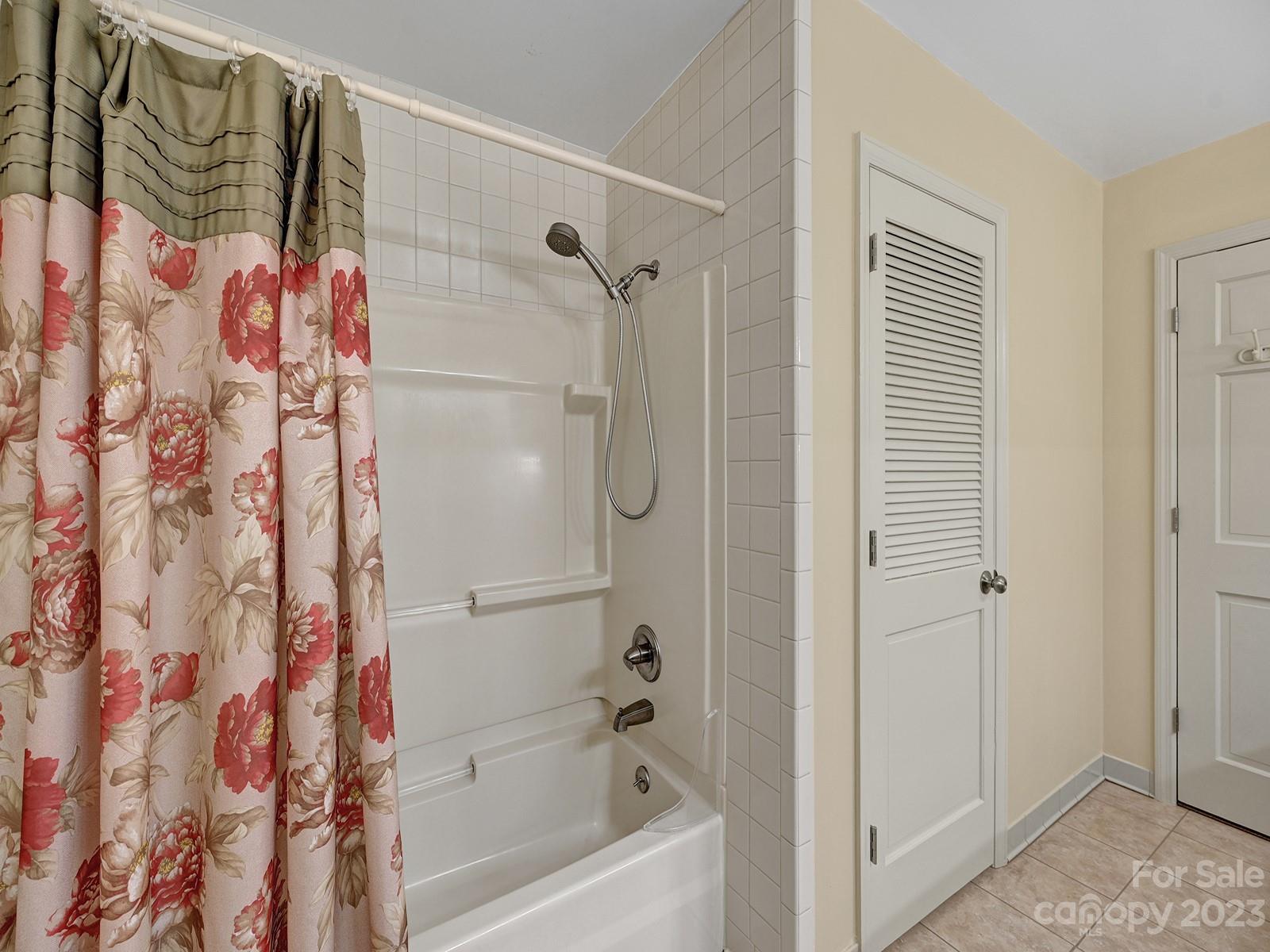 4130 Witherow Road Winston-Salem, NC 27106 - Photo 19 of 39 a bathroom with a shower curtain and a shower