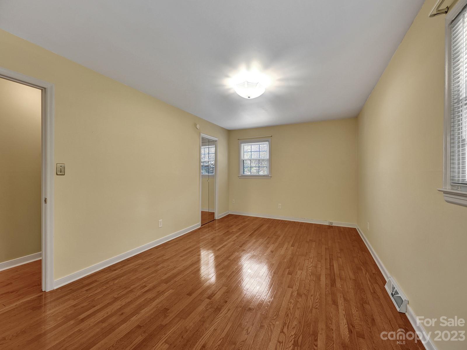 4130 Witherow Road Winston-Salem, NC 27106 - Photo 24 of 39 an empty room with wooden floor and windows