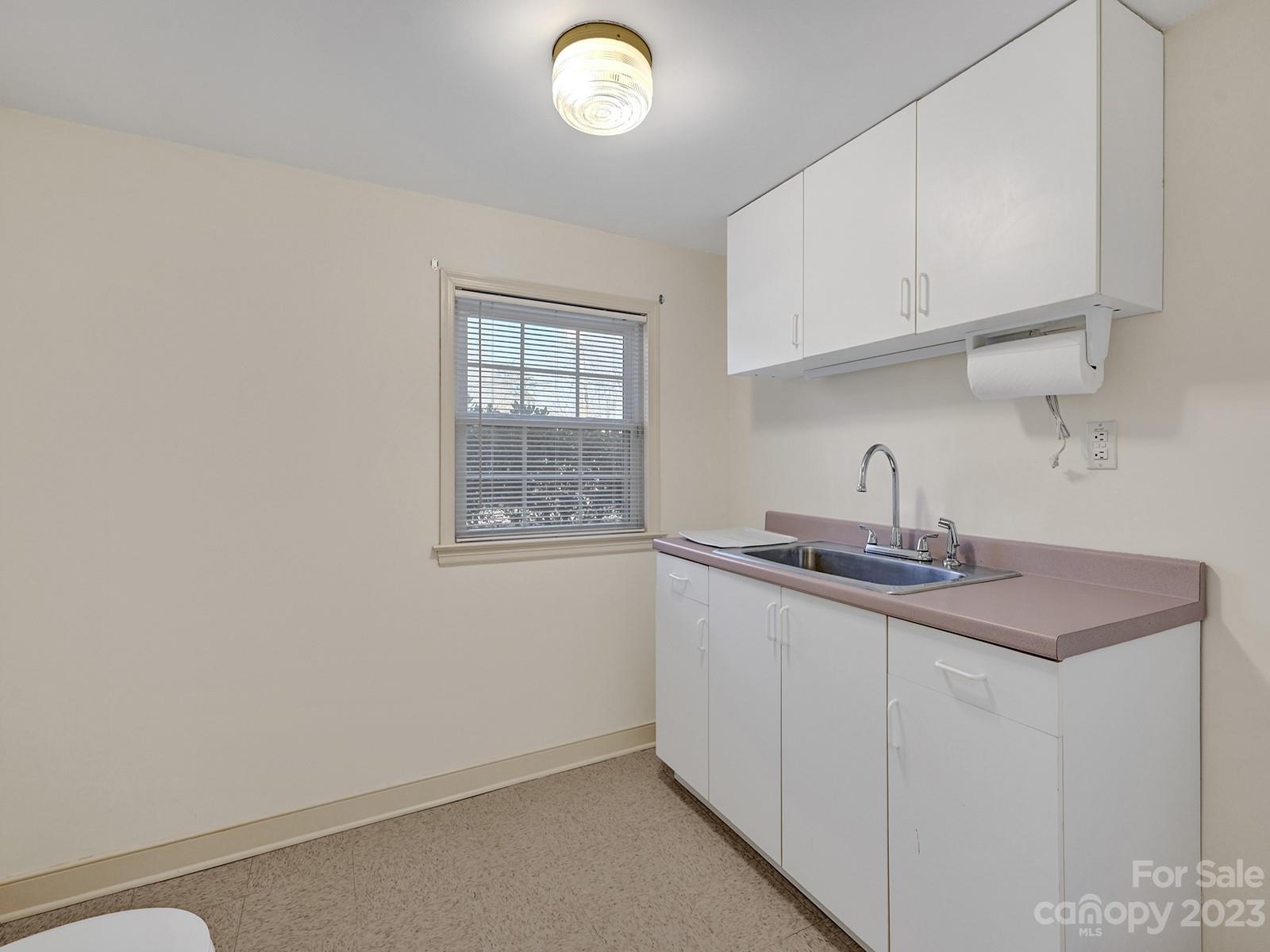 4130 Witherow Road Winston-Salem, NC 27106 - Photo 27 of 39 a kitchen with stainless steel appliances granite countertop a sink and a white cabinets