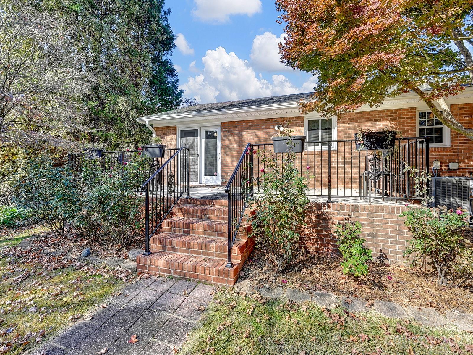 4130 Witherow Road Winston-Salem, NC 27106 - Photo 32 of 39 a front view of house with yard and trees around