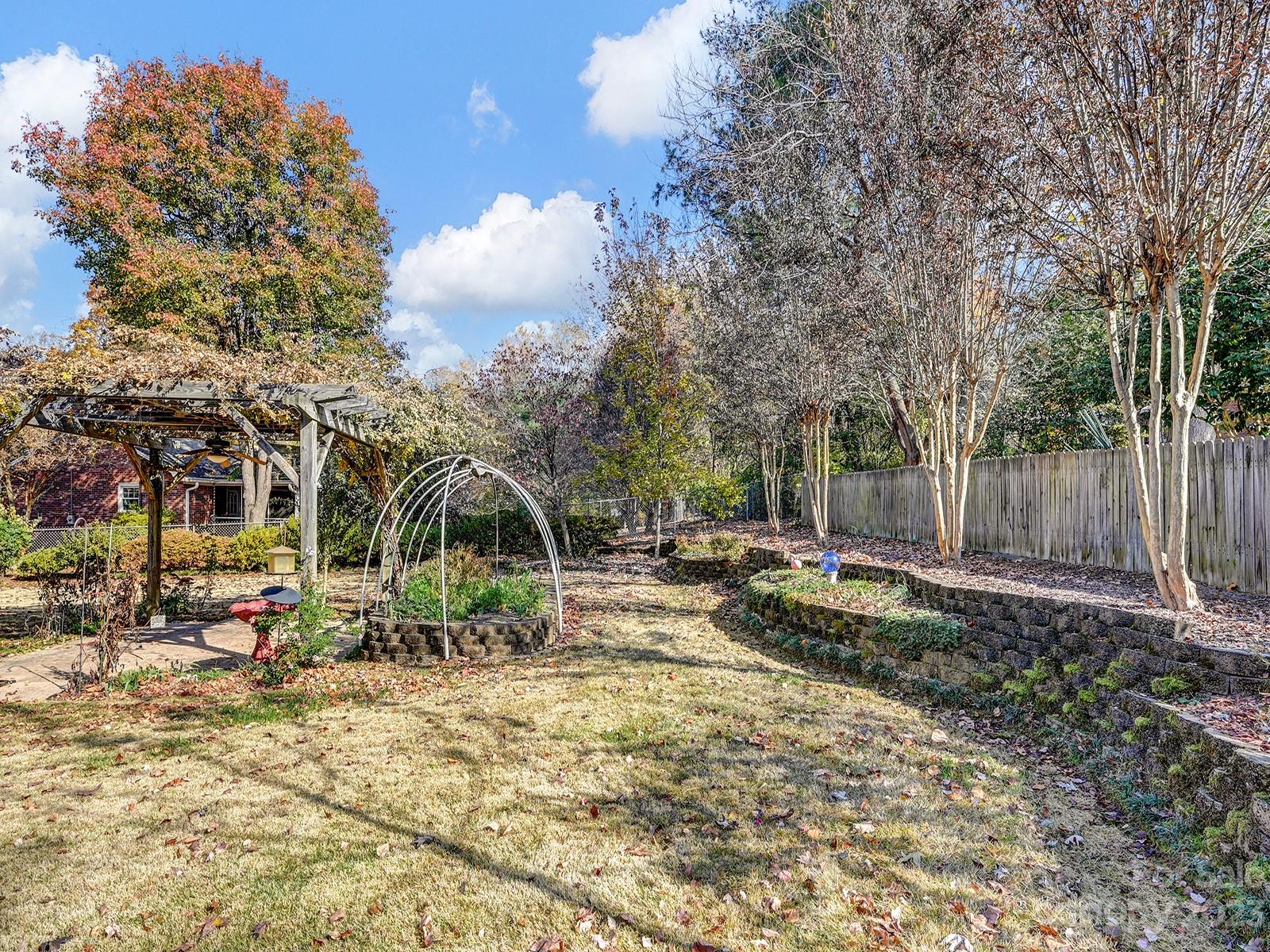 4130 Witherow Road Winston-Salem, NC 27106 - Photo 39 of 39 a view of a wooden house with a yard and sitting area