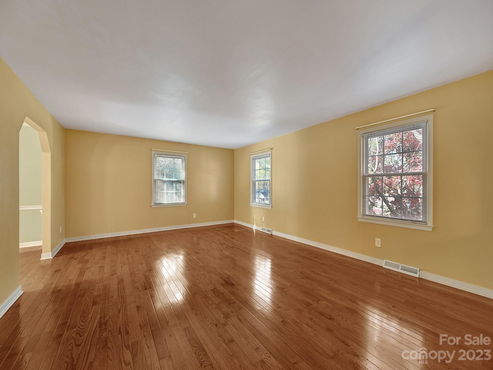 4130 Witherow Road Winston-Salem, NC 27106 - Photo 8 of 39 a view of an empty room with wooden floor and a window
