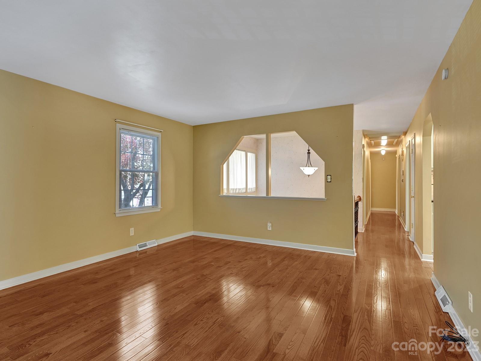 4130 Witherow Road Winston-Salem, NC 27106 - Photo 9 of 39 an empty room with wooden floor and windows