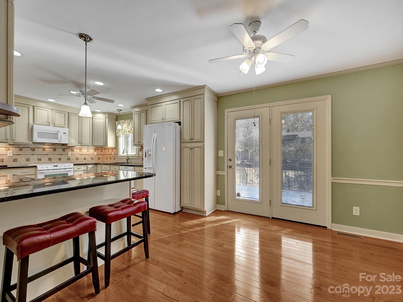 4130 Witherow Road Winston-Salem, NC 27106 - Photo 10 of 39 a view of a kitchen with furniture and wooden floor