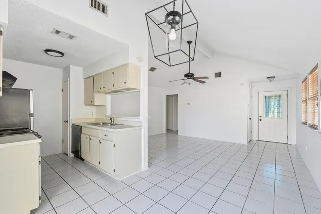 a kitchen with a sink cabinets and stainless steel appliances