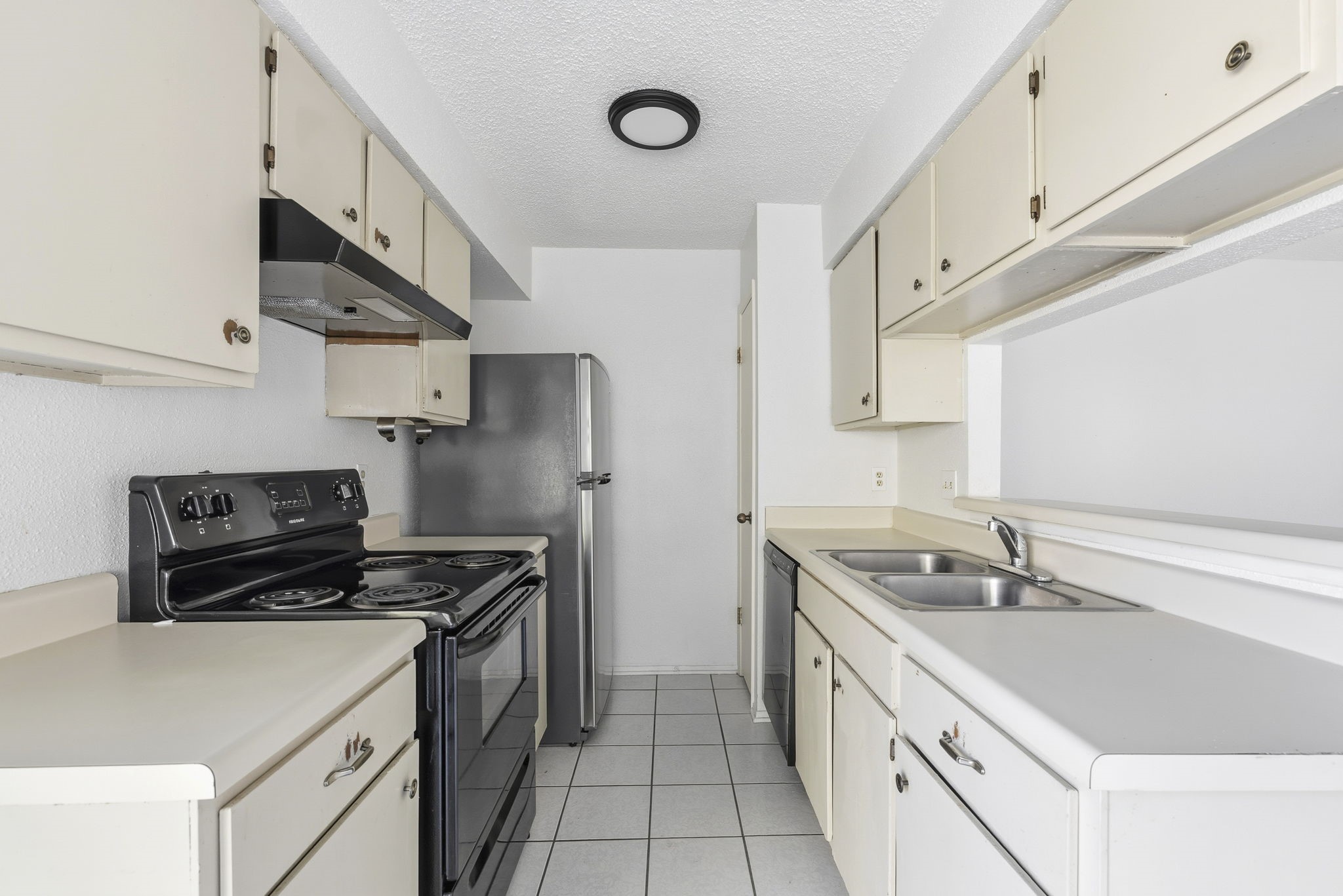 23314 Prairie Bird Drive Spring, TX 77373 - Photo 12 of 20 a kitchen with a sink cabinets and stainless steel appliances