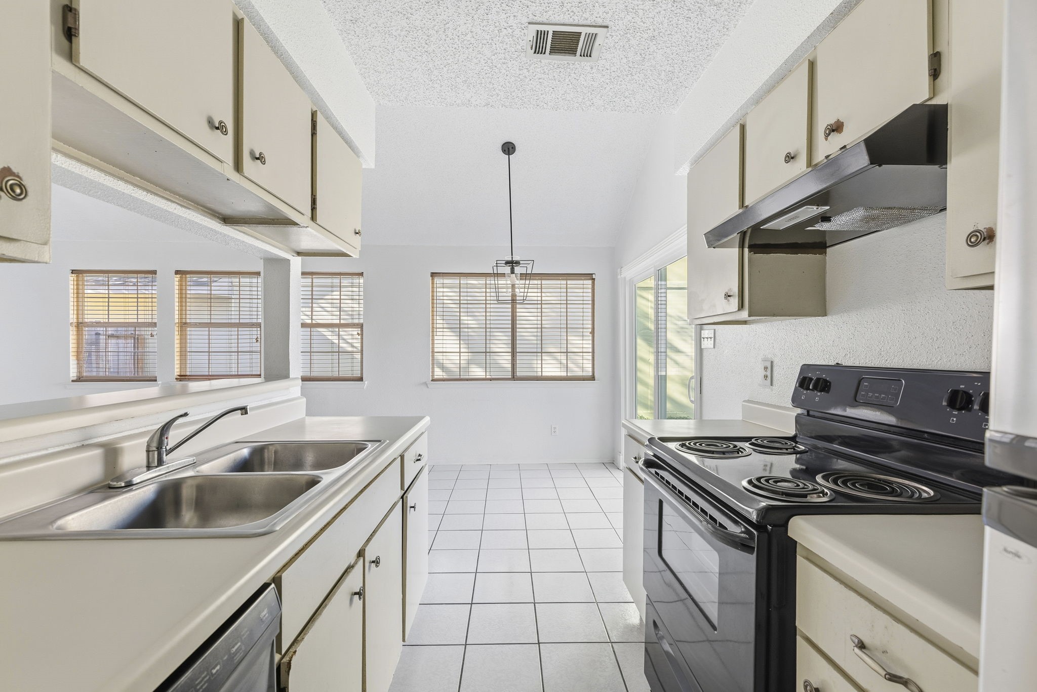 23314 Prairie Bird Drive Spring, TX 77373 - Photo 13 of 20 a kitchen that has a sink and a stove