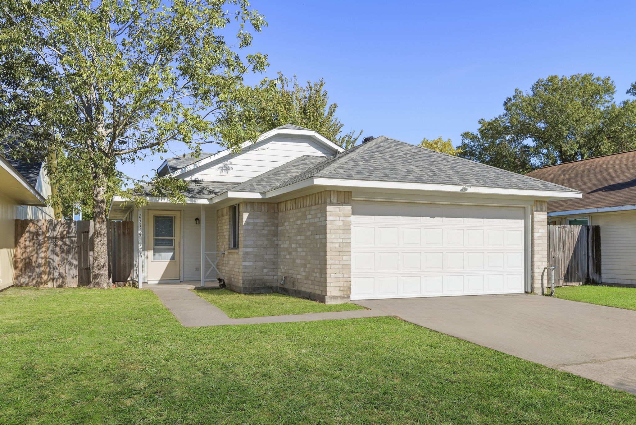 23314 Prairie Bird Drive Spring, TX 77373 - Photo 4 of 20 a front view of a house with a garden and yard