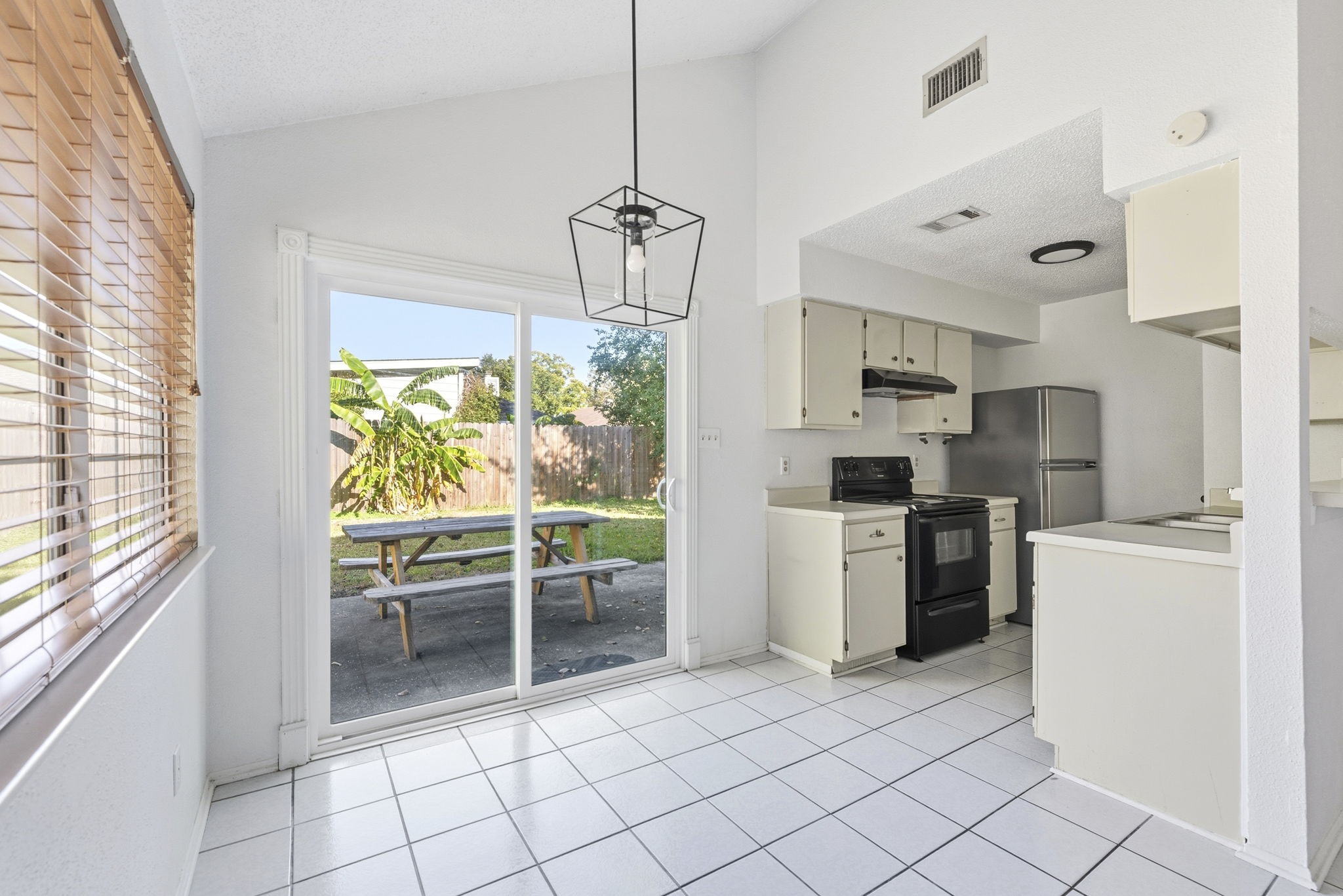 23314 Prairie Bird Drive Spring, TX 77373 - Photo 10 of 20 a kitchen with a refrigerator a stove top oven a sink and a window