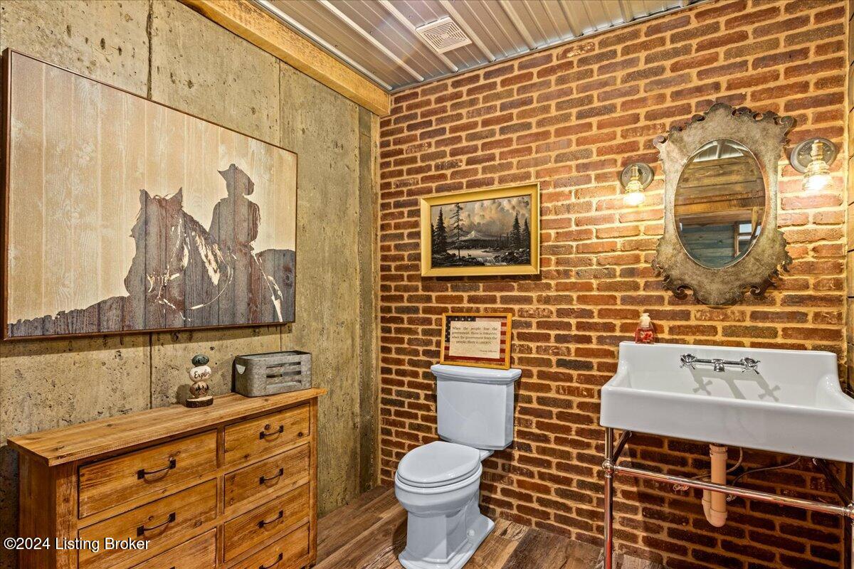 440 Pine Springs Road Clarkson, KY 42726 - Photo 75 of 109 1/2 bath in lower level with barn door brick wall/ old time vanity/sink