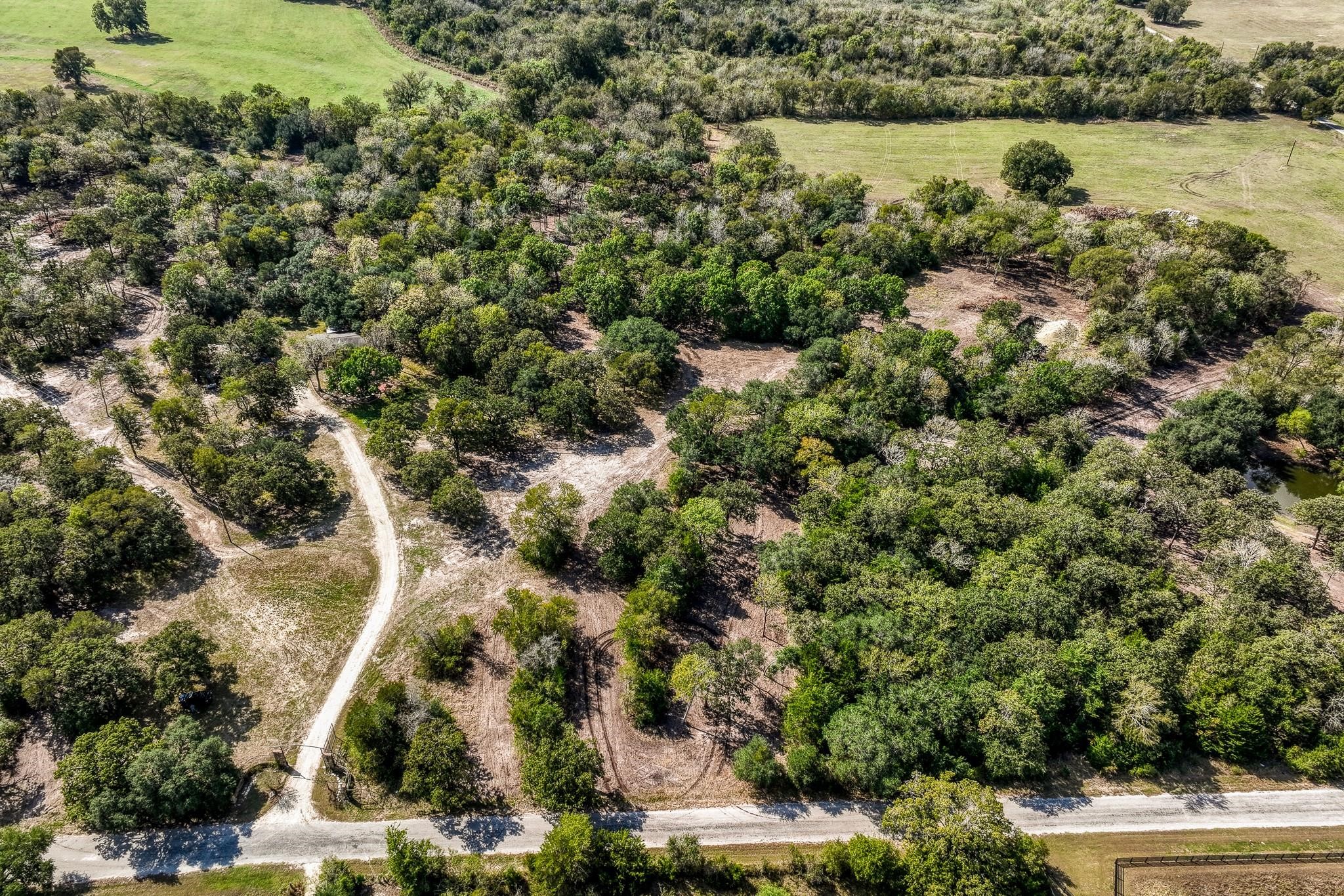 Tbd Sun Oil Road Brenham, TX 77833 - Photo 11 of 37 an aerial view of a houses with yard and lake view