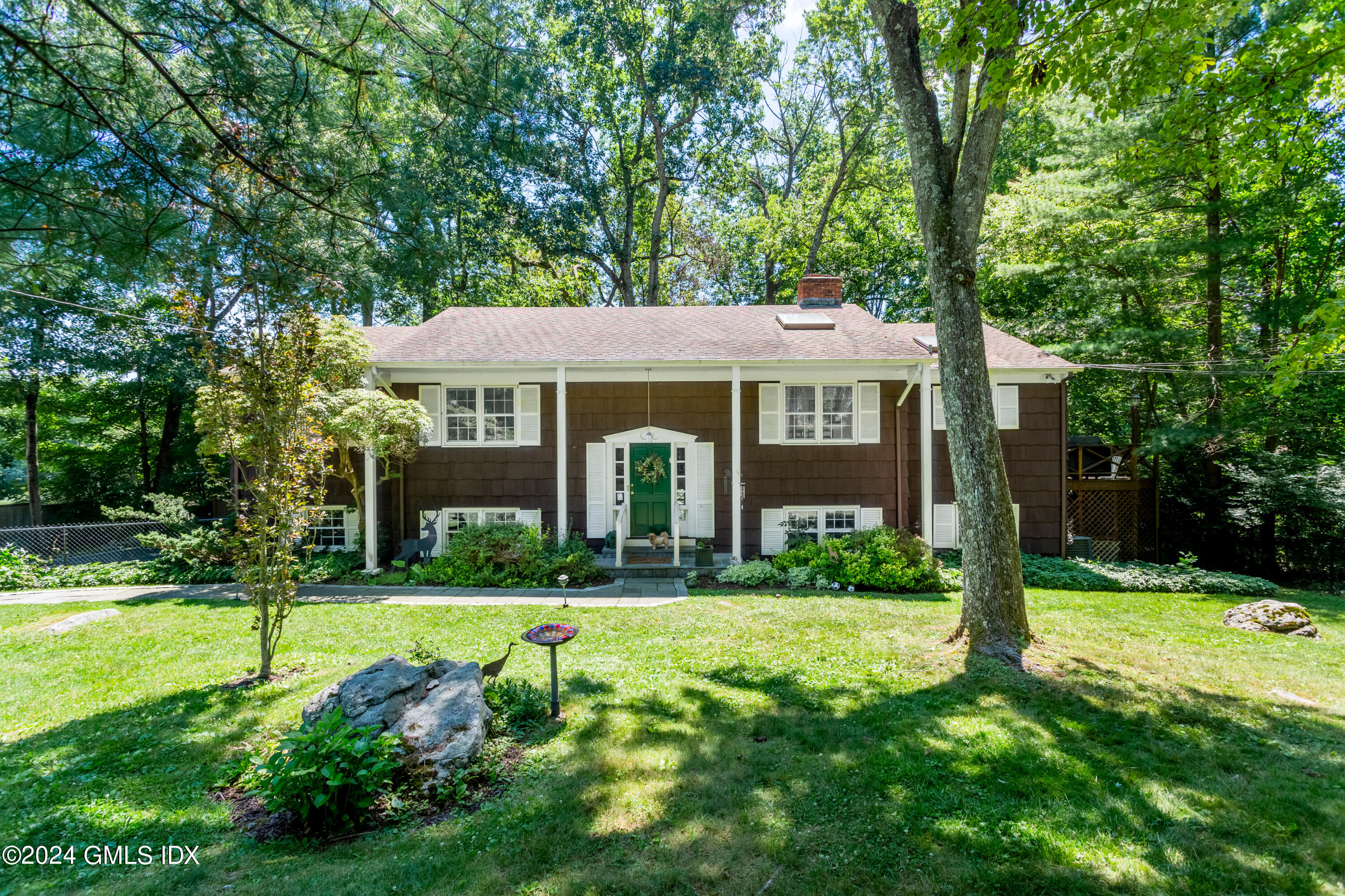 45 Cousins Road Stamford, CT 06903 - Photo 1 of 23 a front view of a house with yard and green space