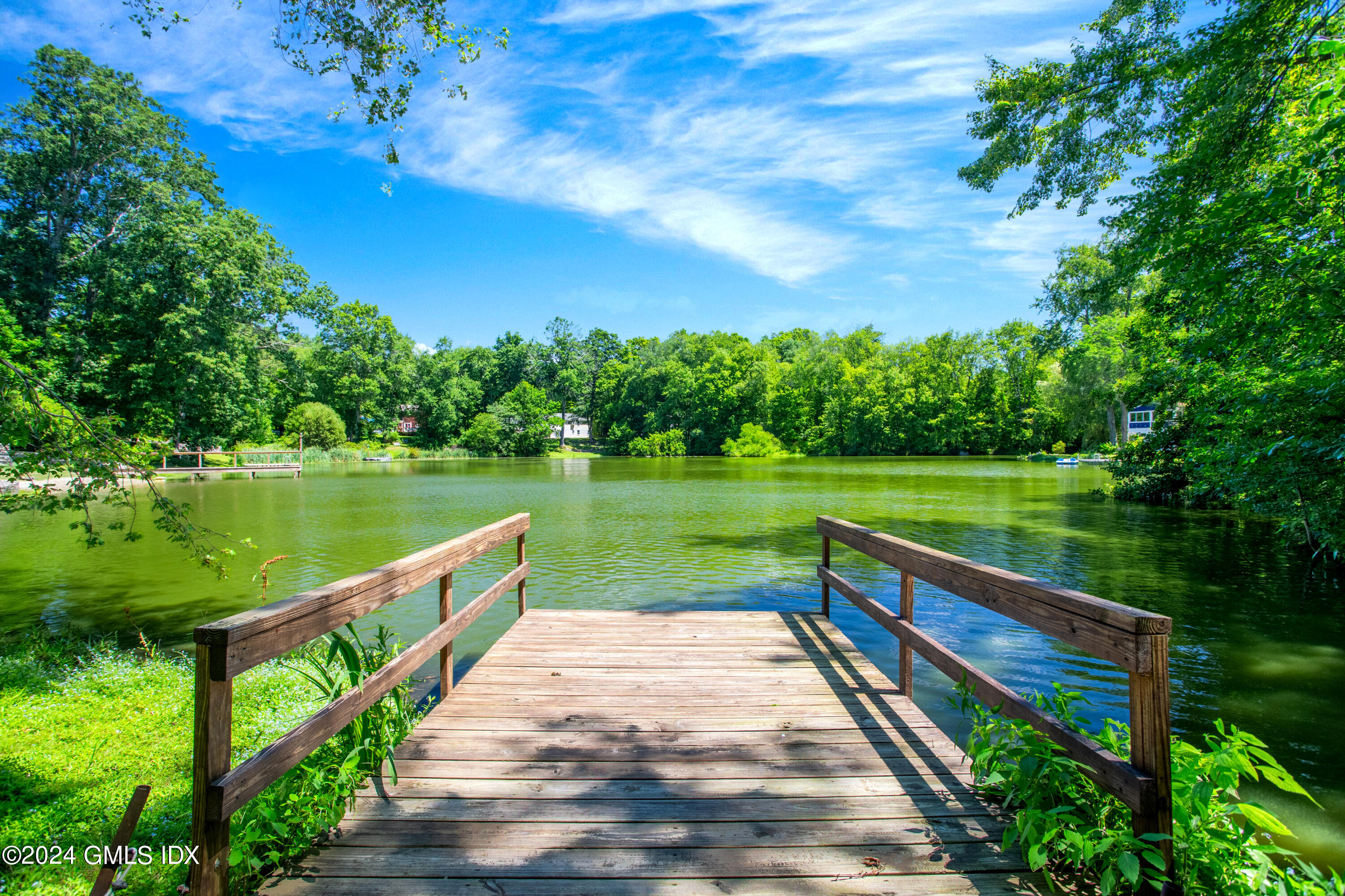 45 Cousins Road Stamford, CT 06903 - Photo 16 of 23 a view of a lake with a garden