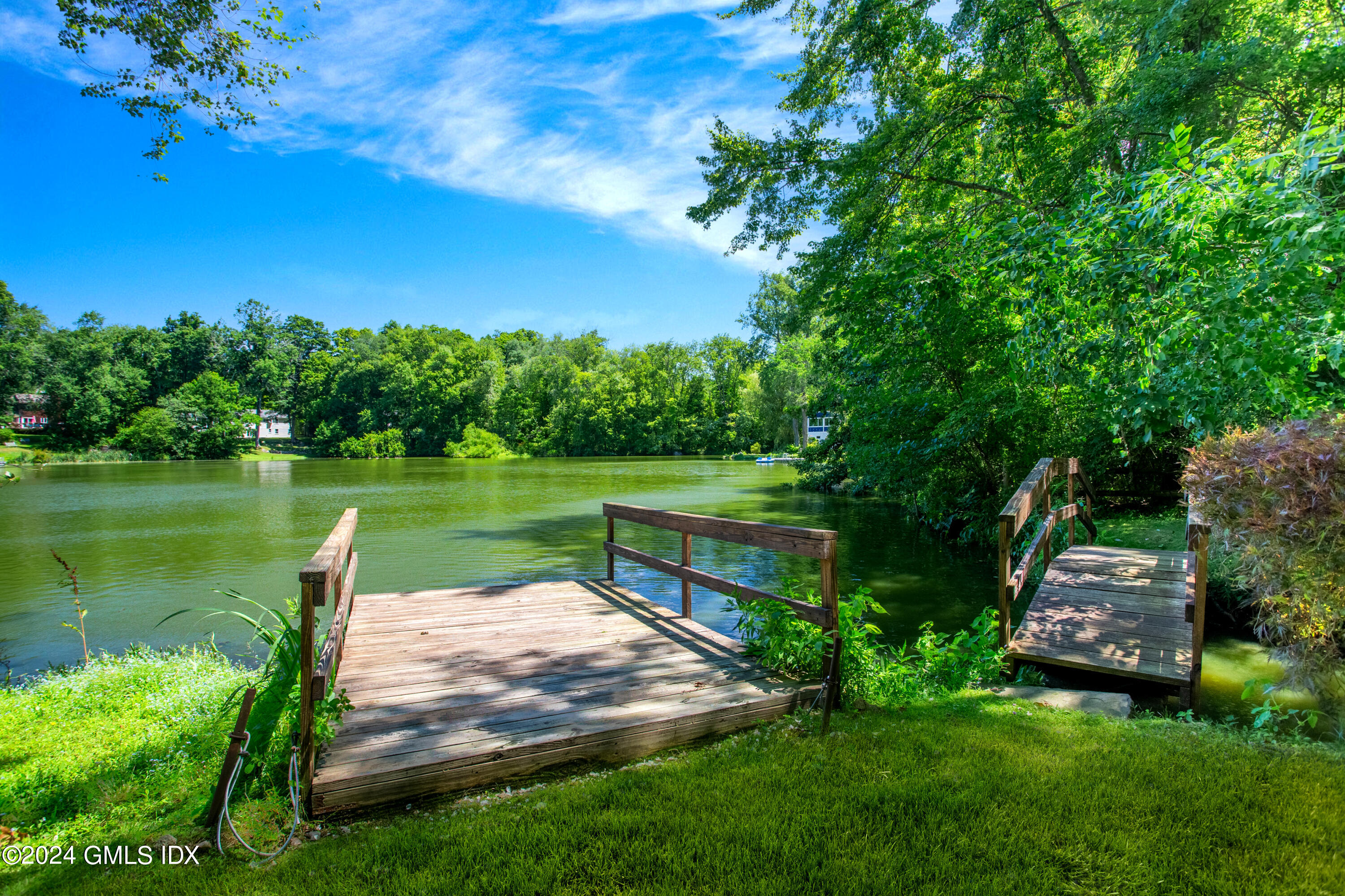 45 Cousins Road Stamford, CT 06903 - Photo 17 of 23 a view of a lake with a yard