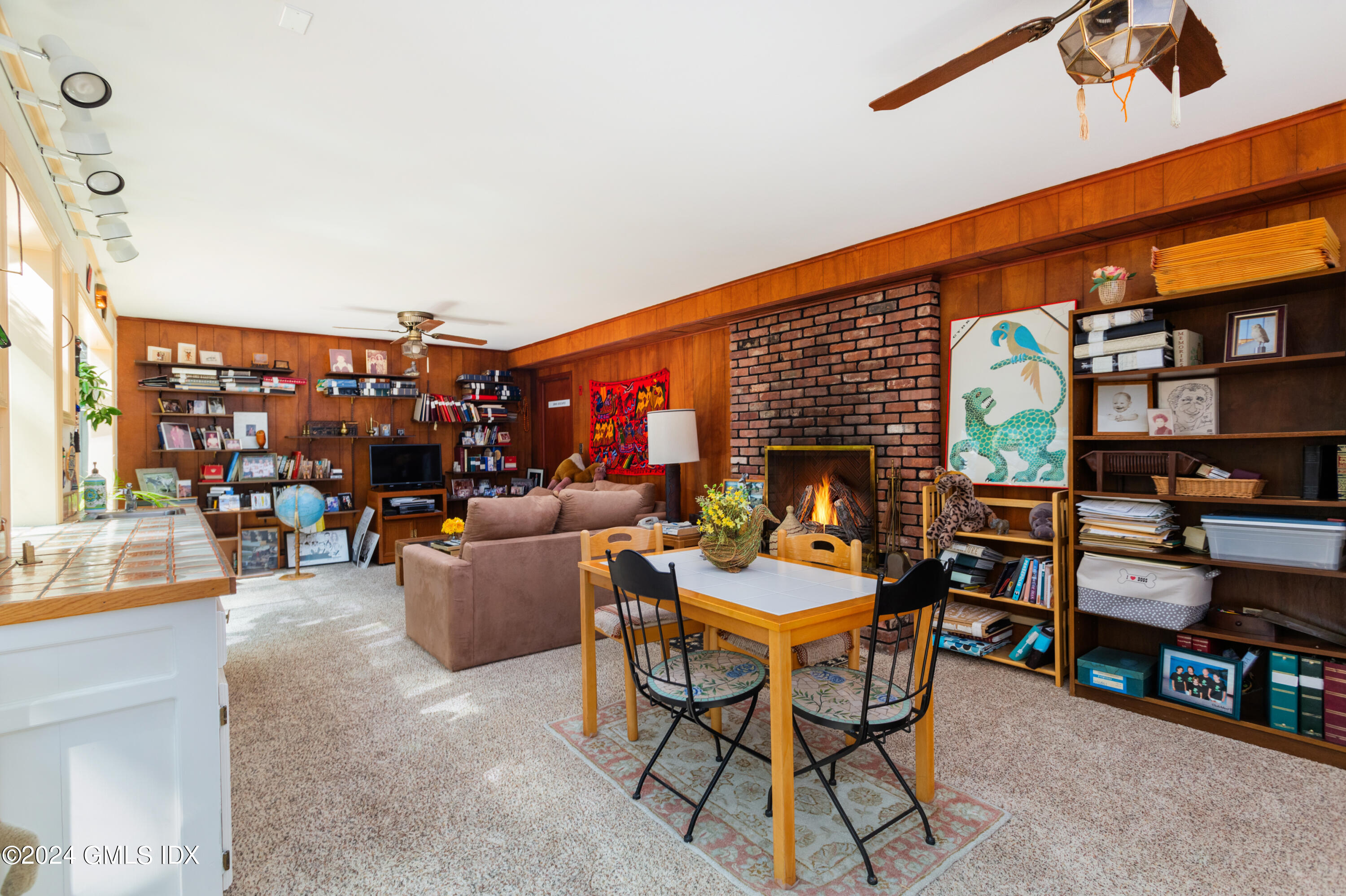 45 Cousins Road Stamford, CT 06903 - Photo 10 of 23 a living room with lots of furniture and a book shelf