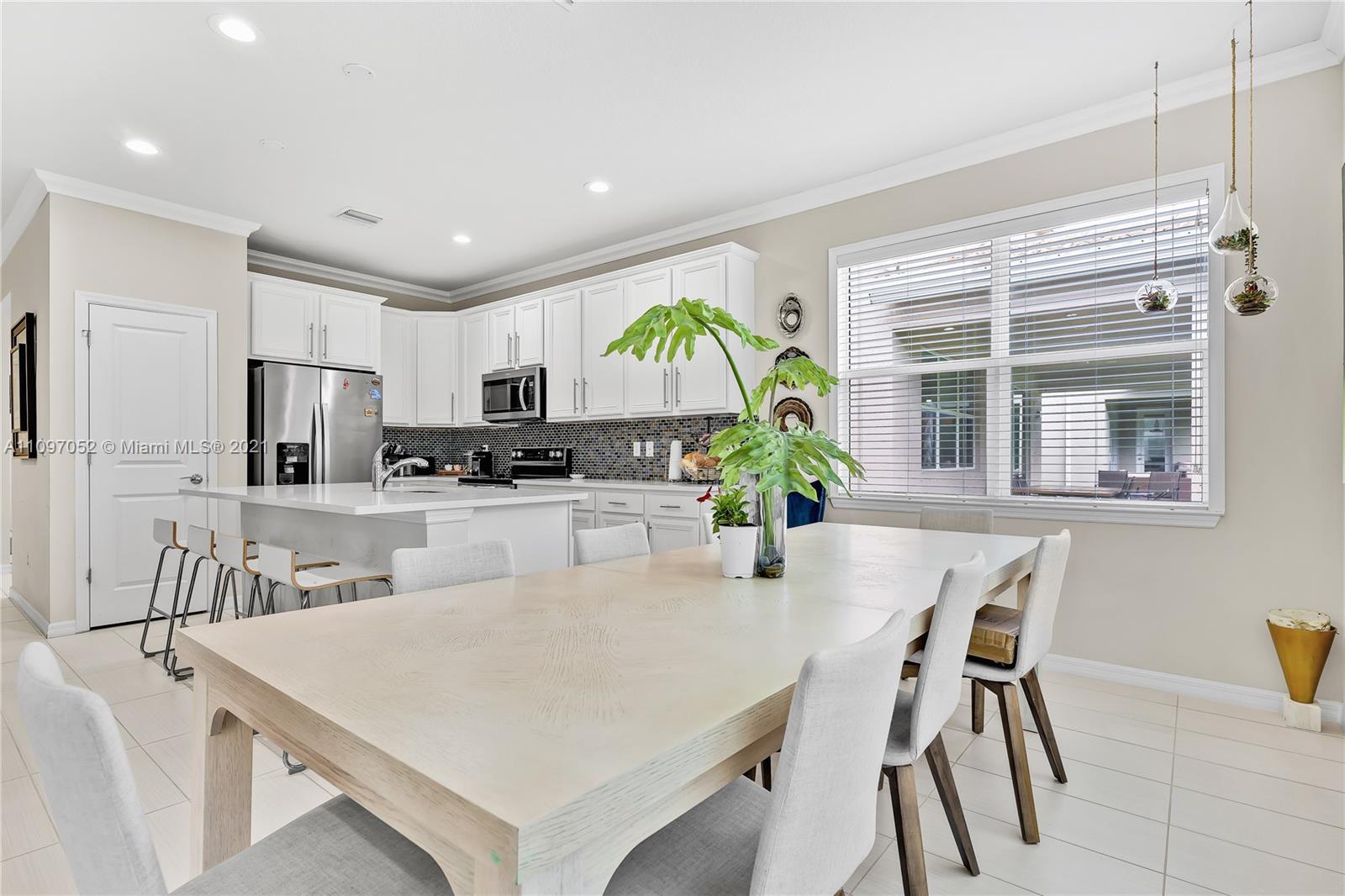 4325 Large Leaf Lane Hollywood, FL 33021 - Photo 26 of 42 a kitchen with stainless steel appliances granite countertop sink microwave and white cabinets