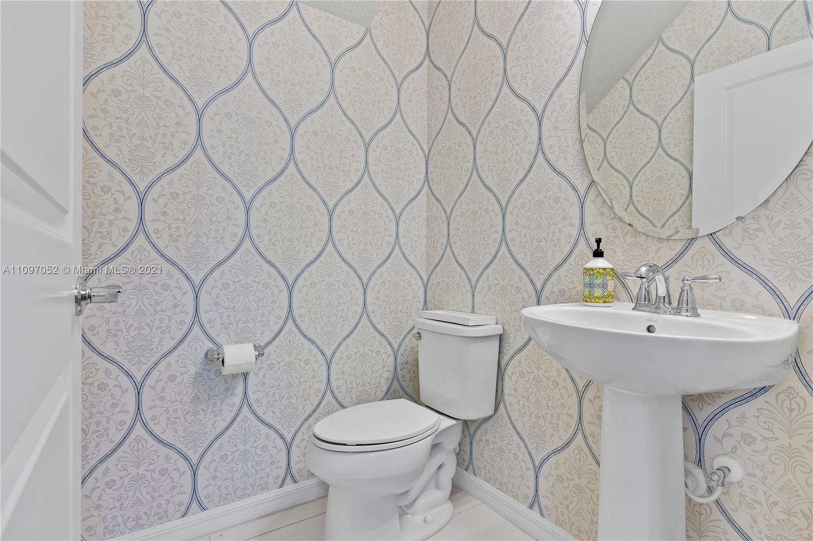 4325 Large Leaf Lane Hollywood, FL 33021 - Photo 29 of 42 a white toilet sitting next to a white sink