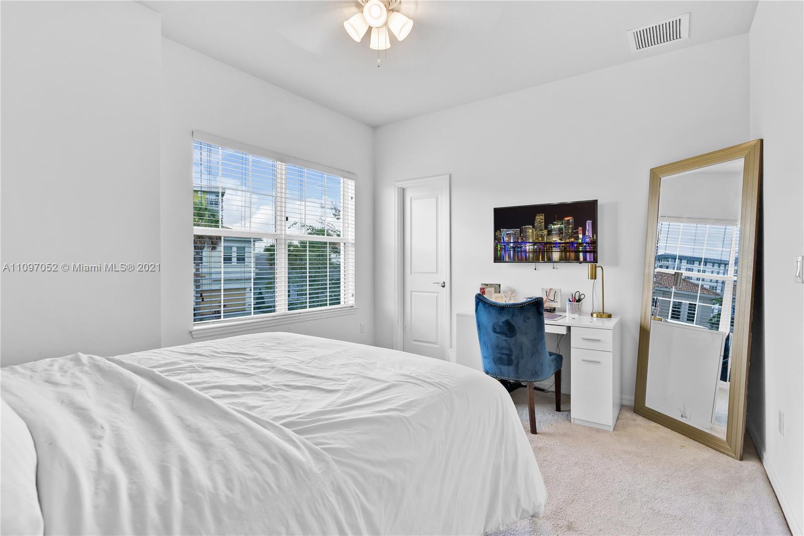 4325 Large Leaf Lane Hollywood, FL 33021 - Photo 32 of 42 a bedroom with a bed and a flat tv screen on dresser