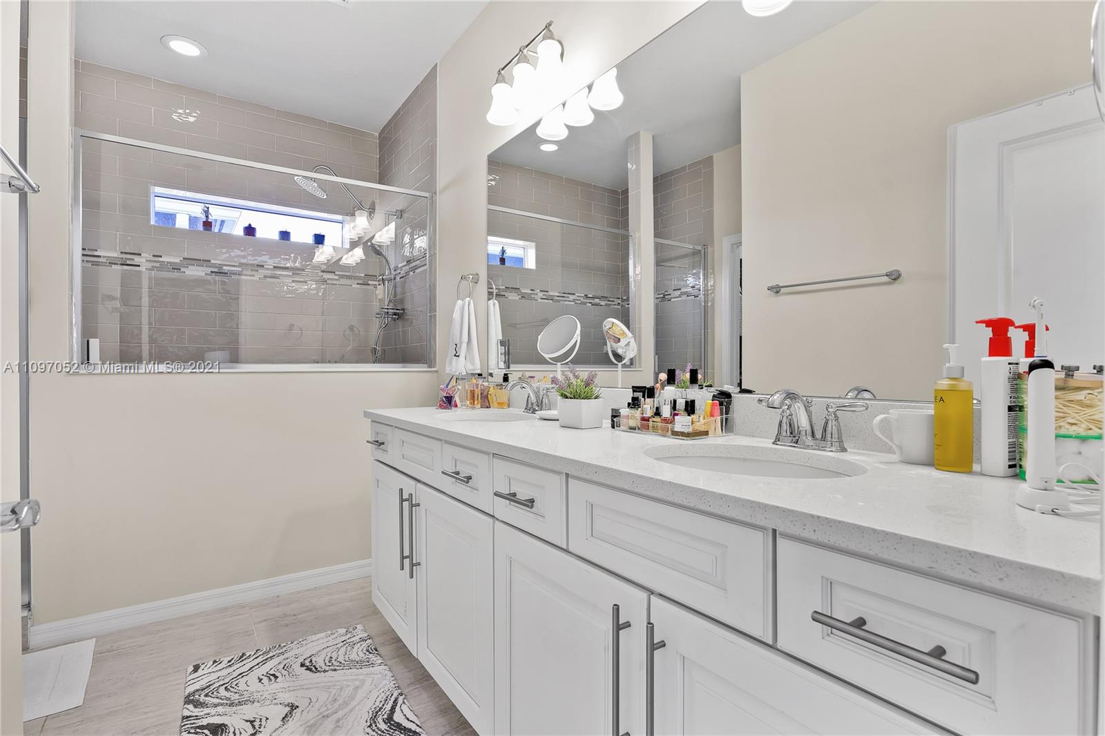 4325 Large Leaf Lane Hollywood, FL 33021 - Photo 38 of 42 a bathroom with a sink vanity and a mirror