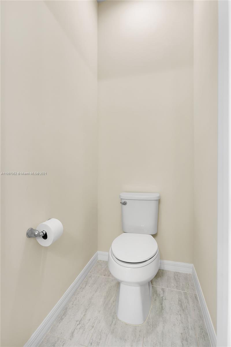 4325 Large Leaf Lane Hollywood, FL 33021 - Photo 41 of 42 a white toilet sitting next to a white wall