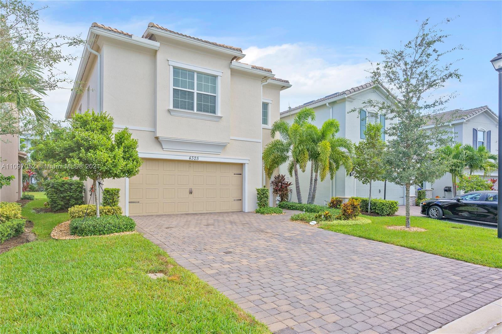 4325 Large Leaf Lane Hollywood, FL 33021 - Photo 9 of 42 a front view of a house with a yard and potted plants