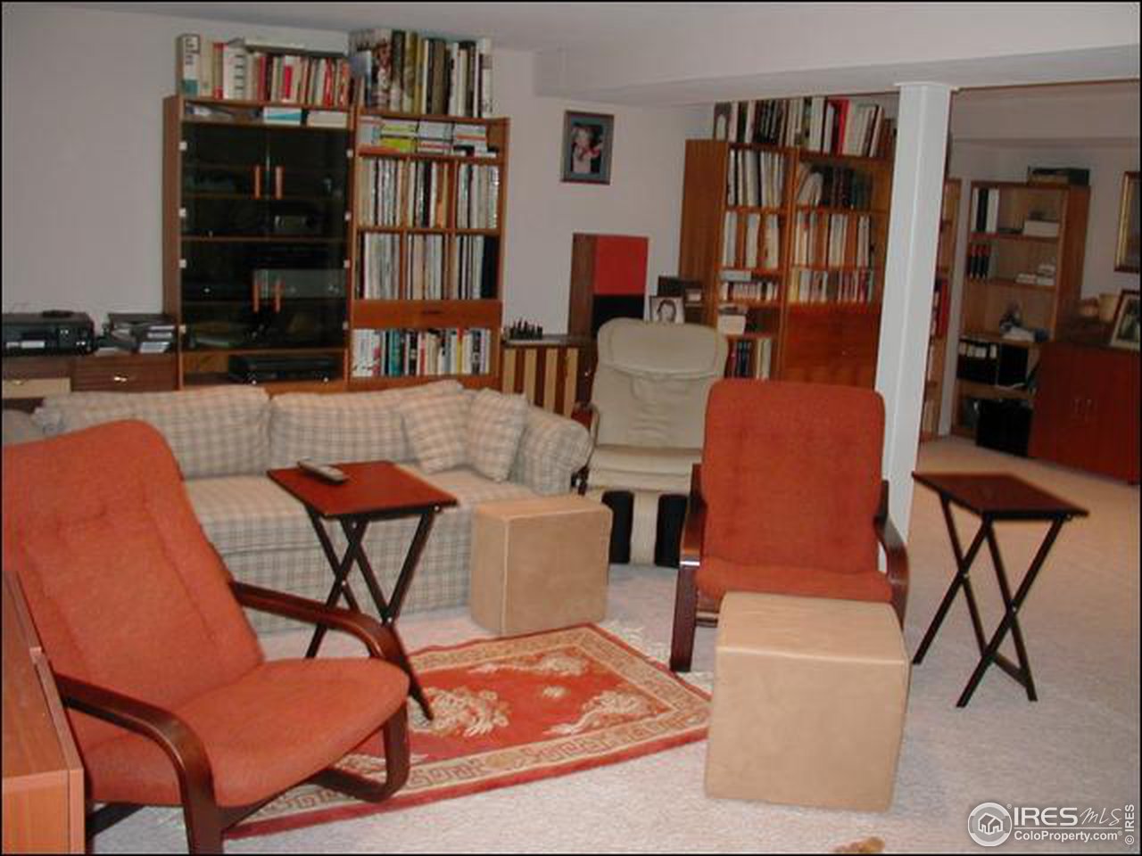7223 Four Rivers Road Boulder, CO 80301 - Photo 12 of 12 a living room with fireplace furniture and a book shelf