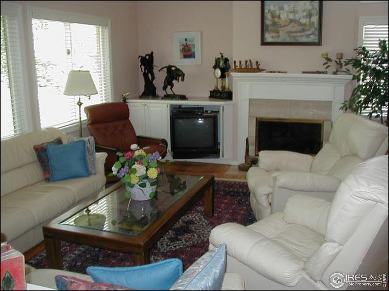 7223 Four Rivers Road Boulder, CO 80301 - Photo 8 of 12 a living room with furniture a potted plant and a fireplace