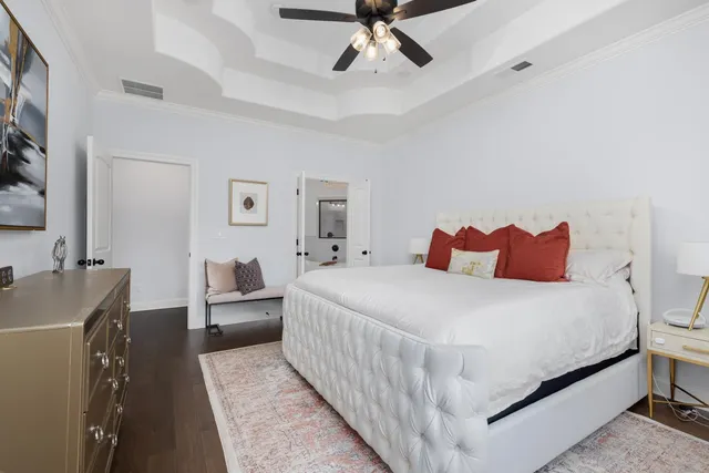 a bedroom with a bed and large window